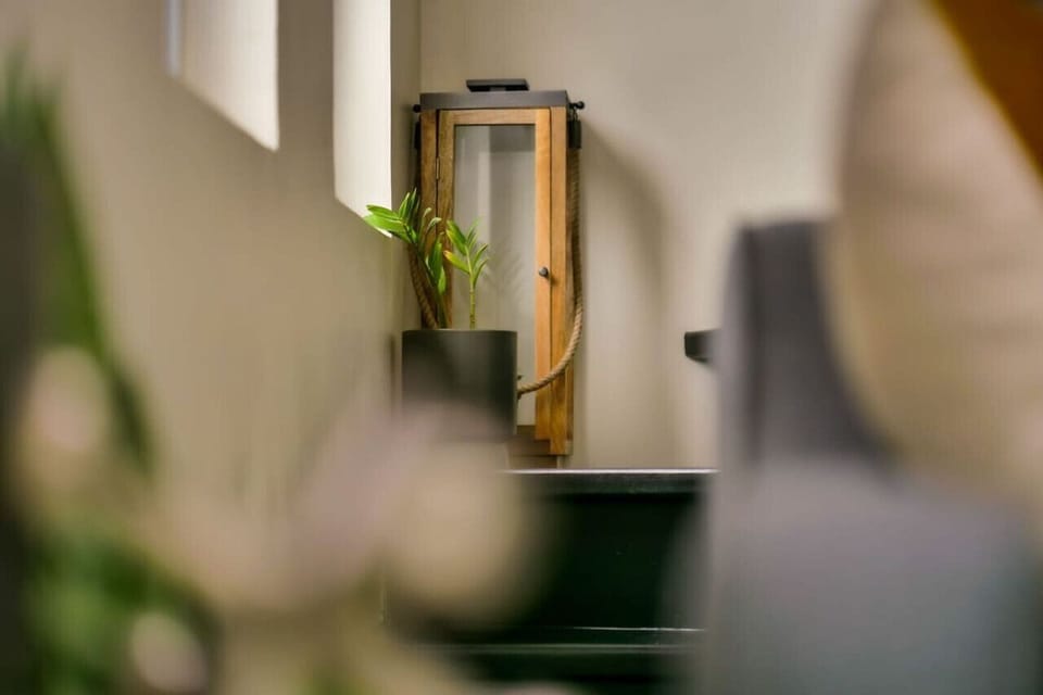 Softly styled corner w/ mirror, greenery & cozy decor accents