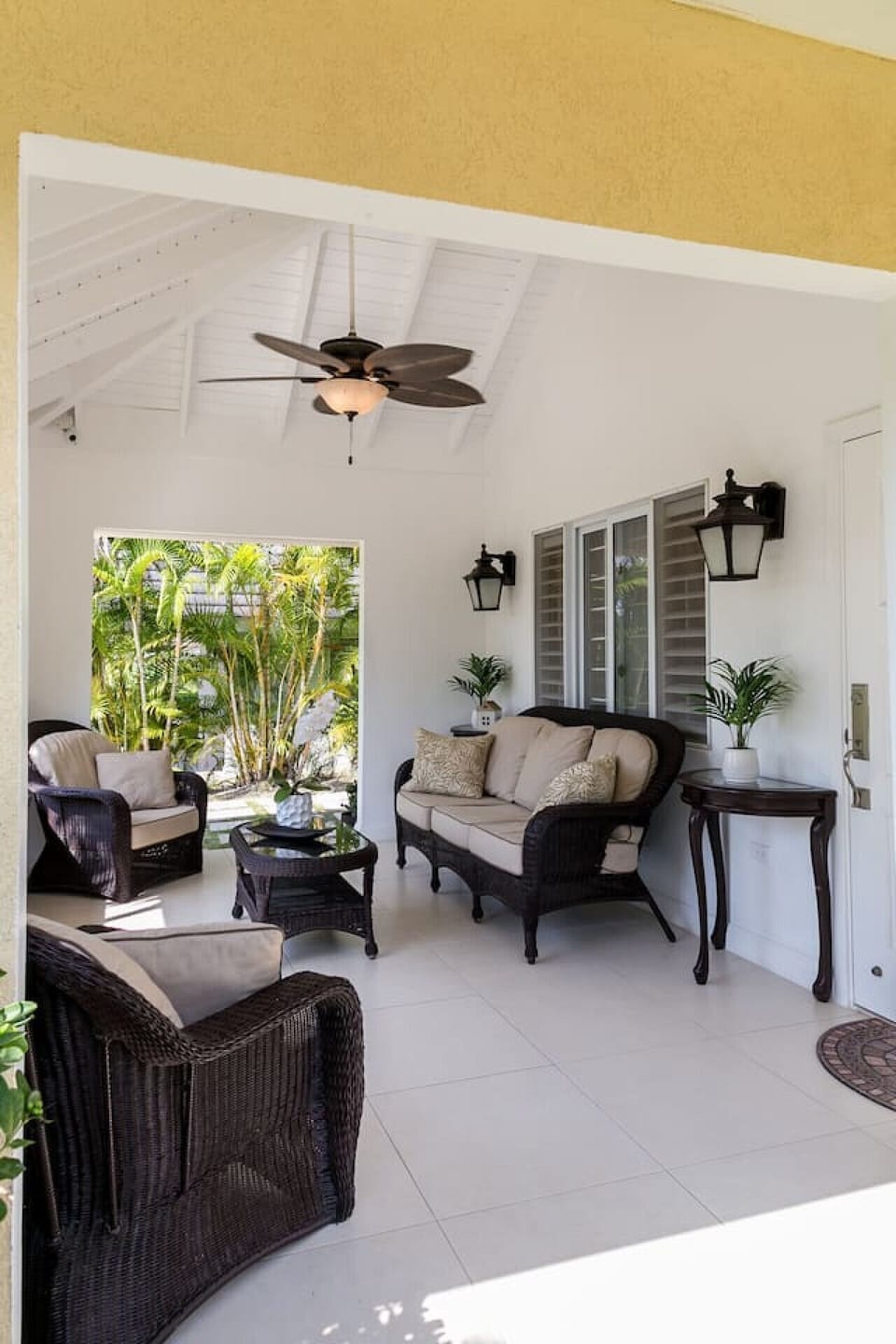 Covered patio w/ cushioned seating, a relaxing spot to enjoy fresh air & garden views