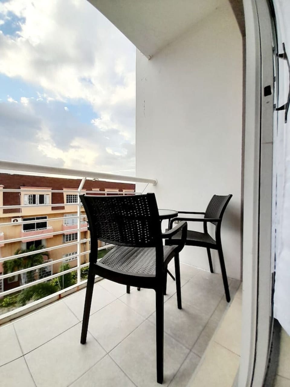 Private balcony w/ seating, ideal for morning coffee overlooking the buildings