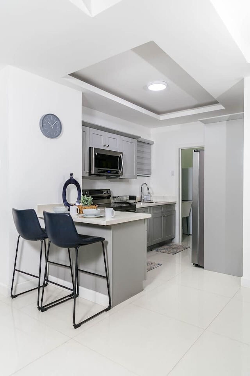 Modern kitchen w/ island seating, sleek counters & everything set for easy meals at home