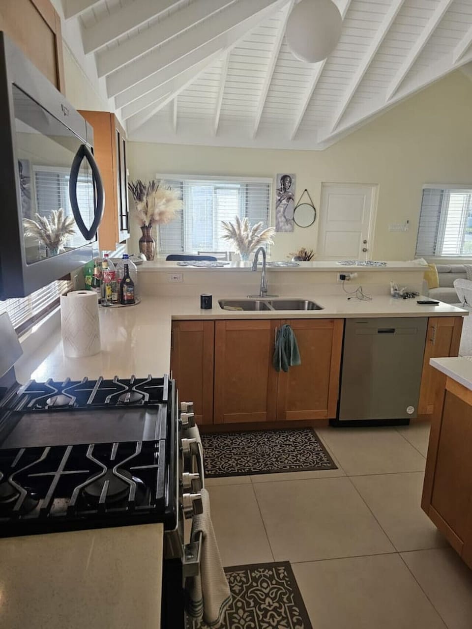 Well-equipped kitchen w/ island seating, stove, sink, and plenty of space to prep & gather.