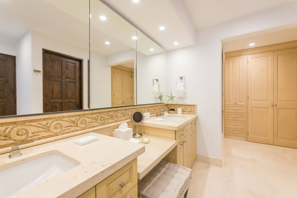 Dual-sink bathroom with elegant finishes and ample space for getting ready.