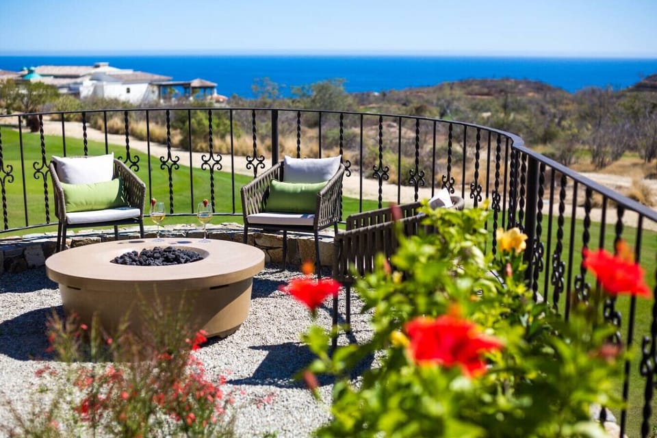 Outdoor seating area surrounded by lush greenery, perfect for morning coffee.