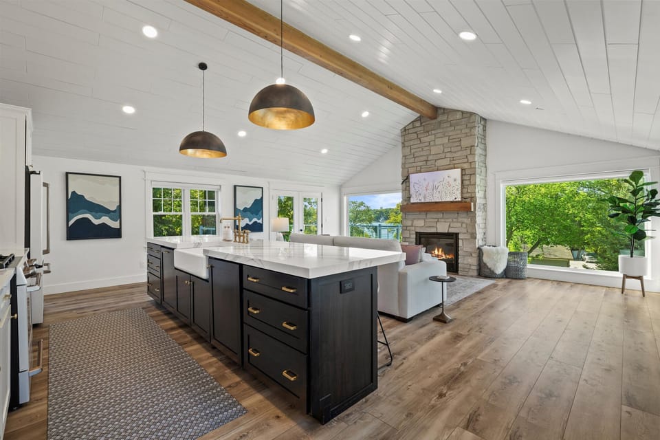 Open-concept living space with gas fireplace and stunning Pewaukee Lake views.
