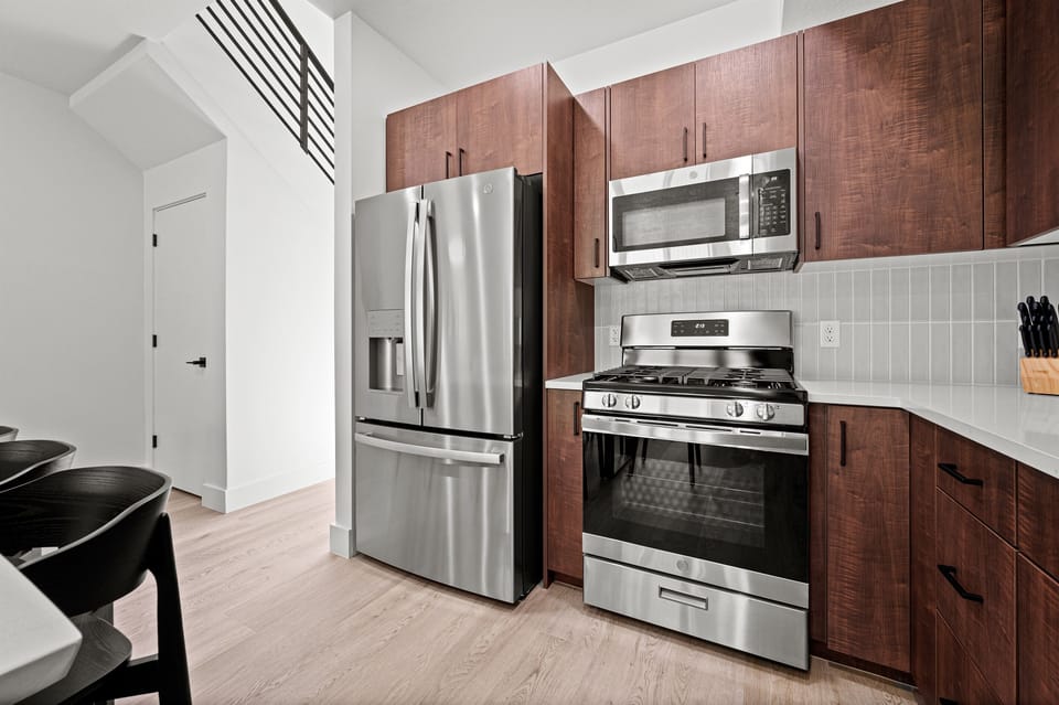 This well-equipped kitchen features a gas stove, dishwasher, microwave, and spacious refrigerator for your convenience and culinary enjoyment.