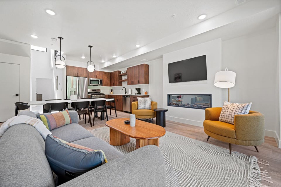 The open-concept living space, complete with a dining area, facilitates effortless conversation with family and friends.