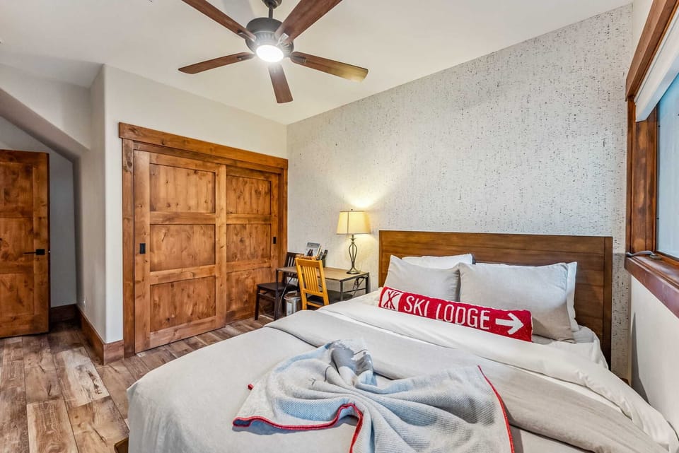 Bedroom 2: Queen bed, dedicated workspace, door to the outside, closet, 38” TV, lower floor
