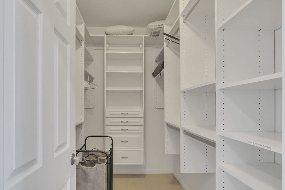 Step into luxury with our spacious walk-in closet, designed to accommodate your entire wardrobe with style