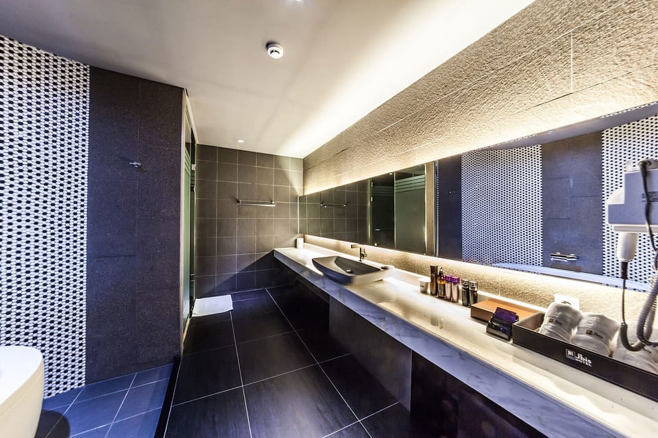 Suite Twin (Extra fee applies for 2+ consecutive nights stay) | Bathroom | Combined shower/tub, hair dryer, bathrobes, slippers