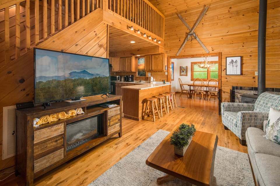 Open-concept living area with soaring ceilings and rustic charm