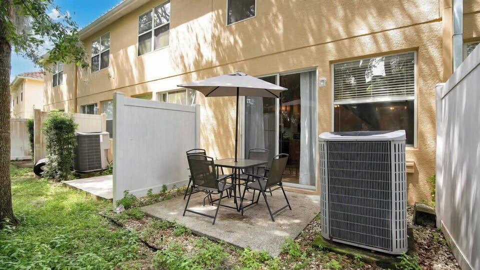 Outdoor patio area with seating and umbrella for relaxing meals.