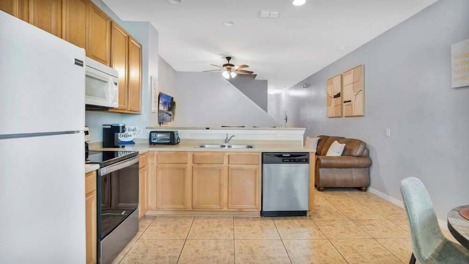 Open kitchen with modern appliances and a view into the living area