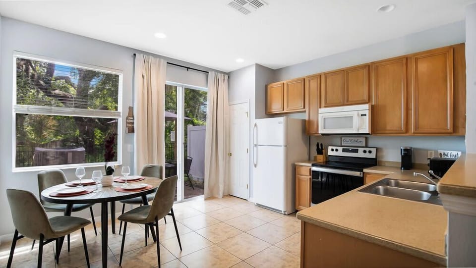 Bright kitchen and dining area with natural light and garden views.