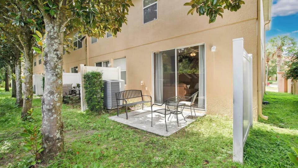 Outdoor patio area with seating surrounded by greenery for relaxing moments.