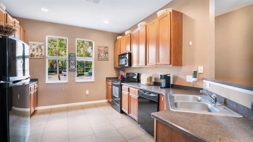Bright kitchen with wooden cabinets and modern appliances.