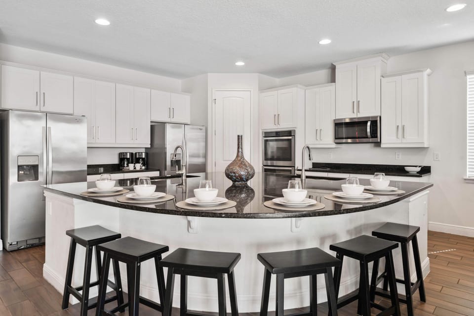 - Open kitchen with double fridge and breakfast bar
- Modern vacation rental perfect for family cooking
- Spacious Orlando home with large kitchen setup