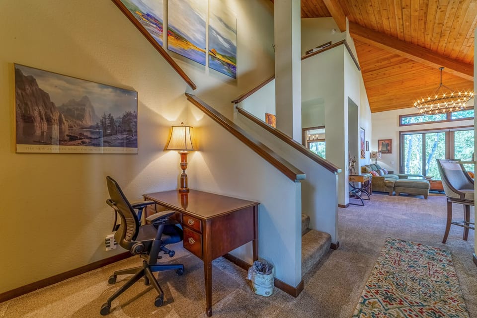 Dedicated workspace with desk and chair on main level.