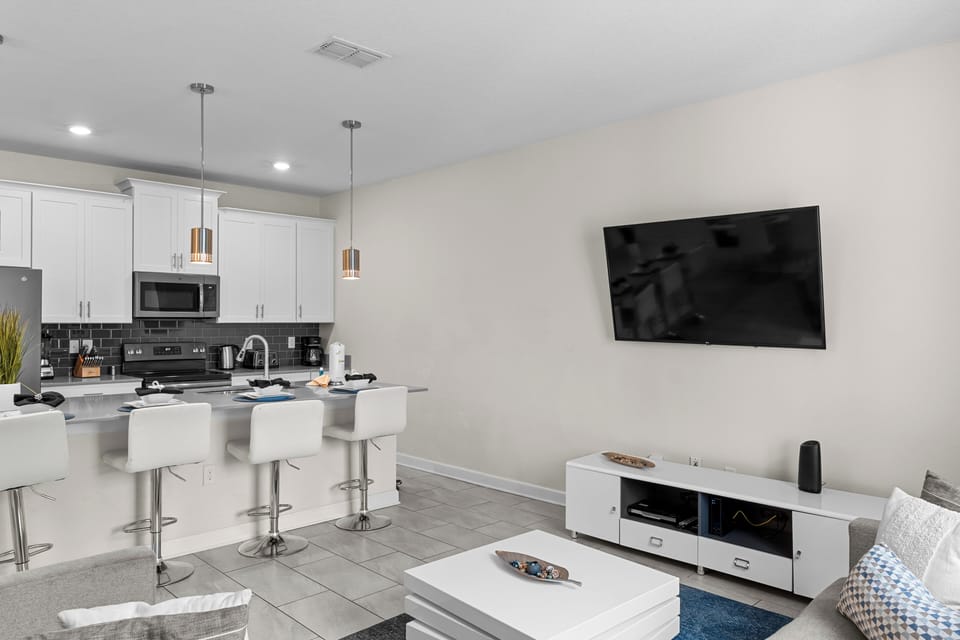 Settle into your sleek open-concept living space where modern kitchen meets cozy lounge—perfect for cooking together and unwinding with evening entertainment.