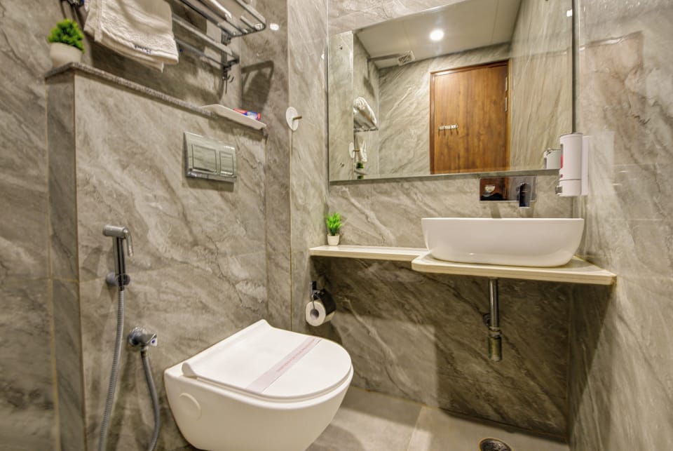 Shower, designer toiletries, slippers, towels