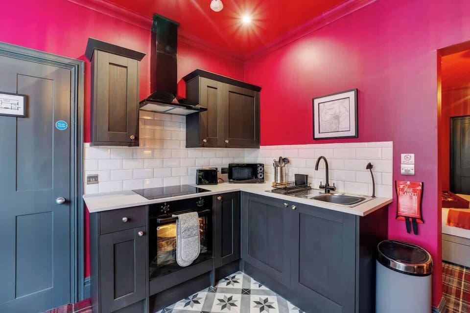 Kitchen equipped with all essentials, including a washer & dryer, oven, fridge and full cookware set.