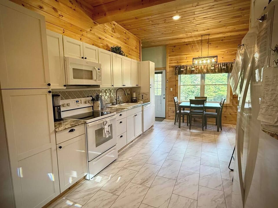Bright open-concept kitchen, fully equipped with modern essentials—perfect for preparing a romantic dinner for two or hosting a family meal in comfort. 
