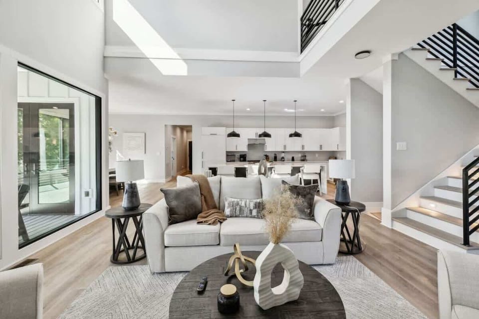 Living room looking into the luxurious kitchen with Quartz waterfall edges.
