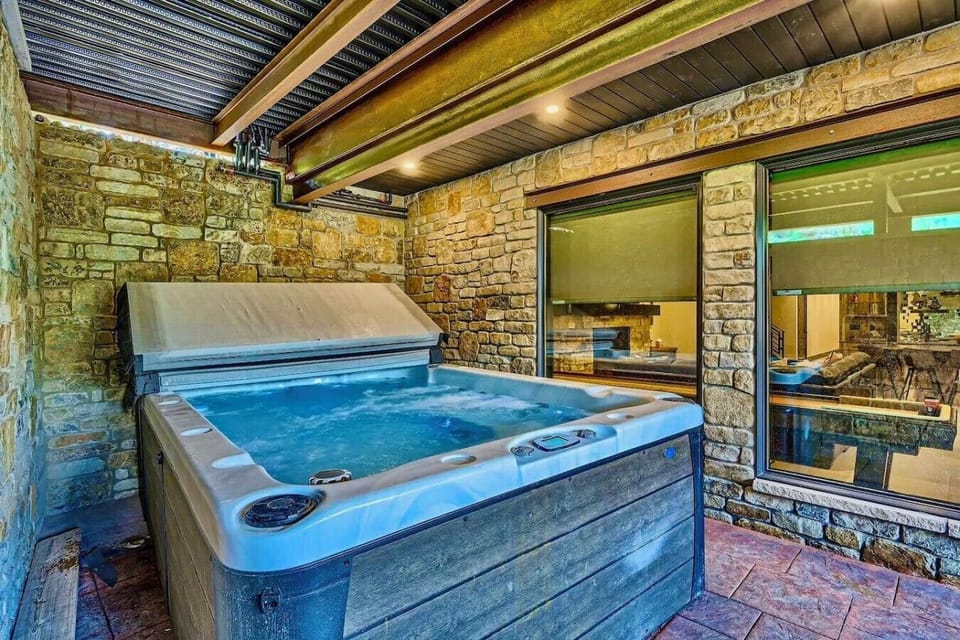 Unwind in the private hot tub with stunning views, offering the perfect space to relax and enjoy the tranquility of your surroundings in this luxurious retreat.