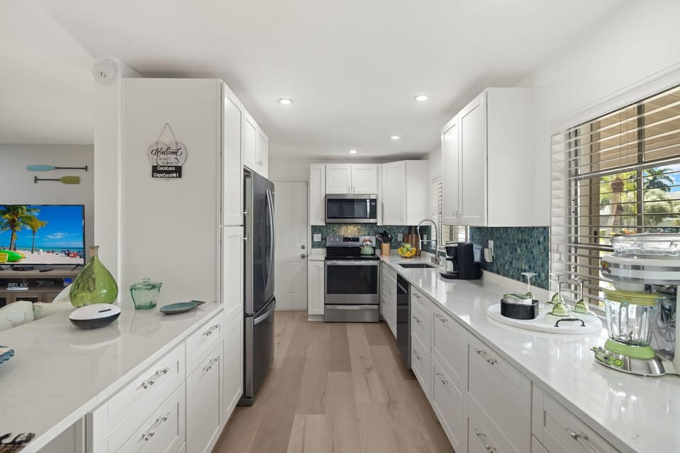 The fully equipped galley kitchen offers stainless steel appliances