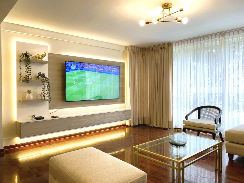 Family Apartment | Living area | 65-inch flat-screen TV with cable channels
