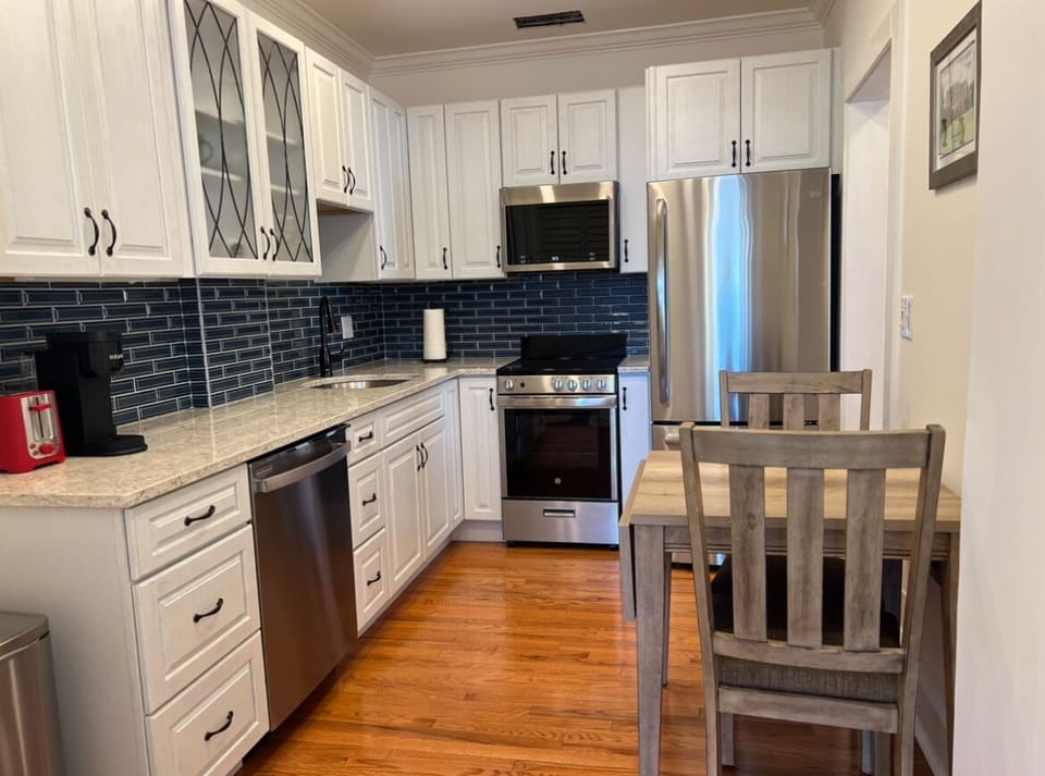 Full kitchen with dishwasher, range with oven and microwave
