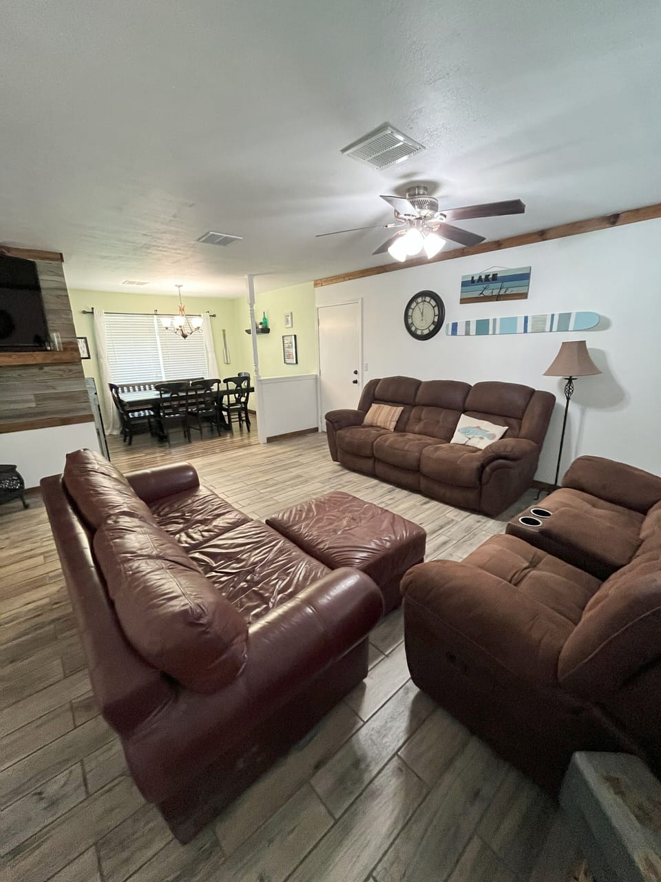 Living room with seating for 8 as well as smart TV with DVD player.