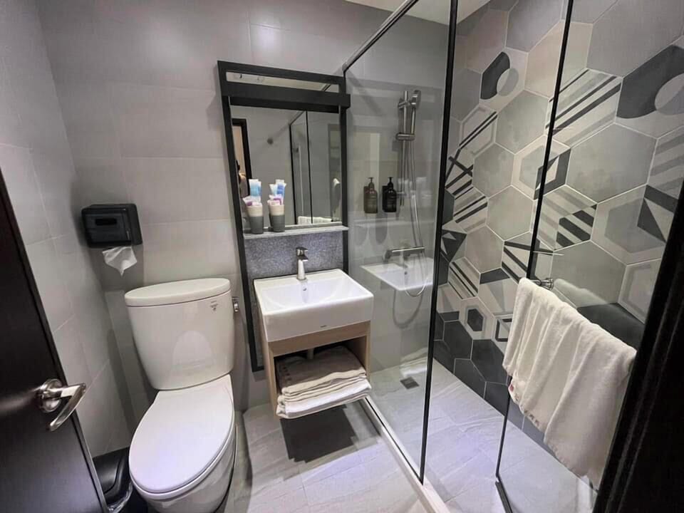 Shower, rainfall showerhead, hair dryer, towels