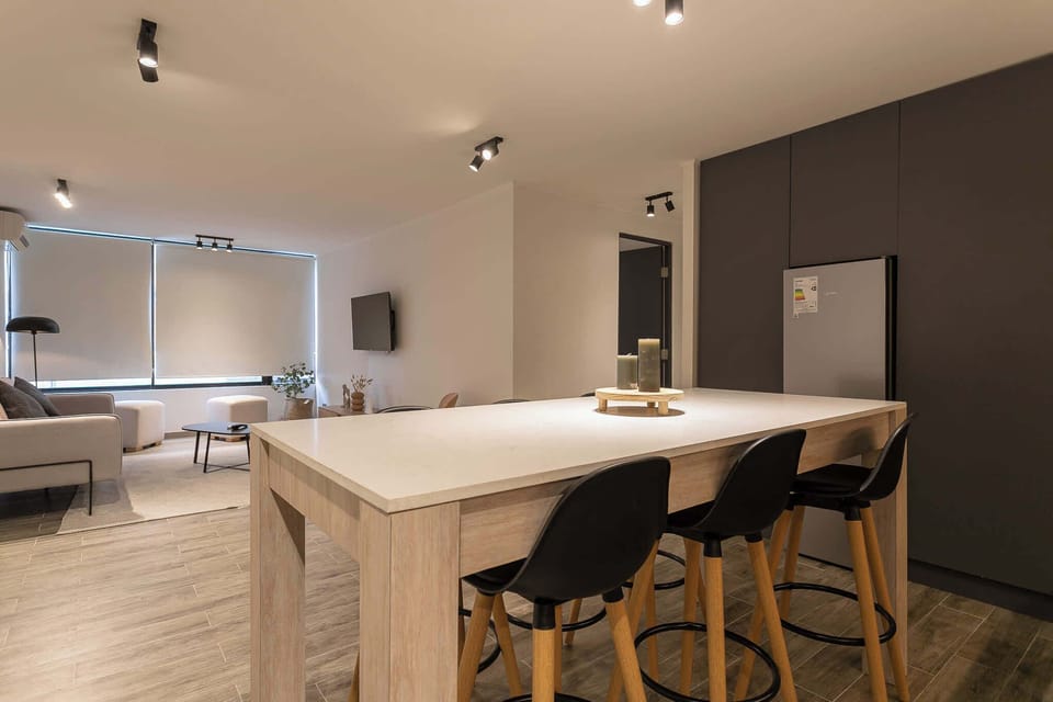 Modern living area with ample seating and stylish decor, perfect for relaxation and entertainment.
