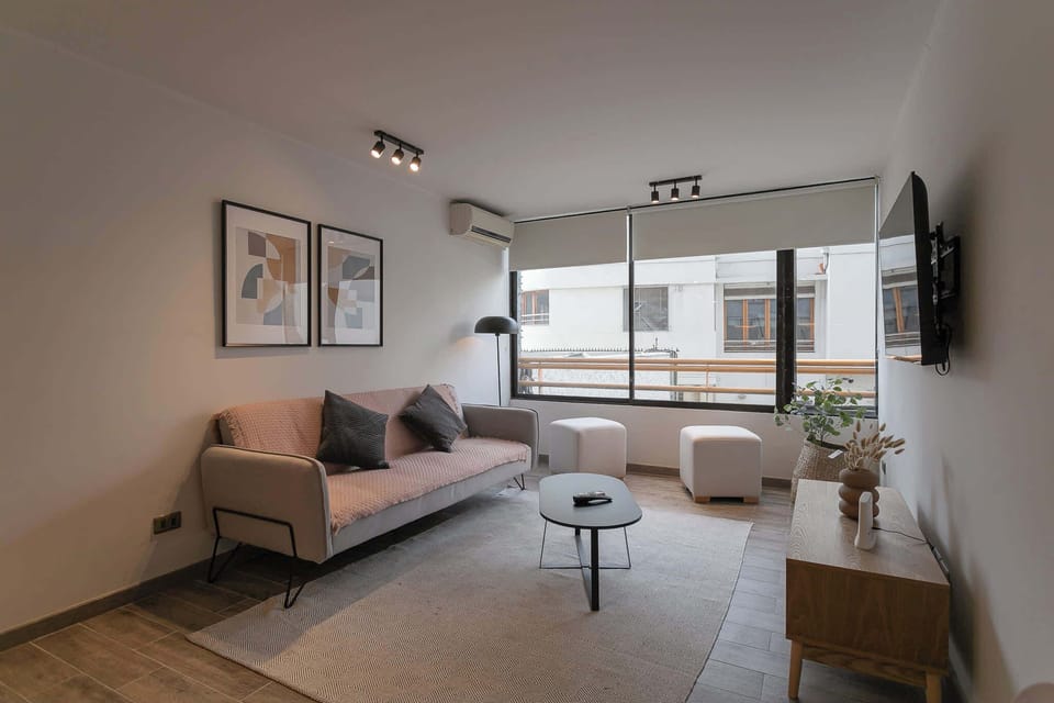 Unwind in a chic living room with modern decor, ample natural light, and cozy seating, perfect for relaxation.