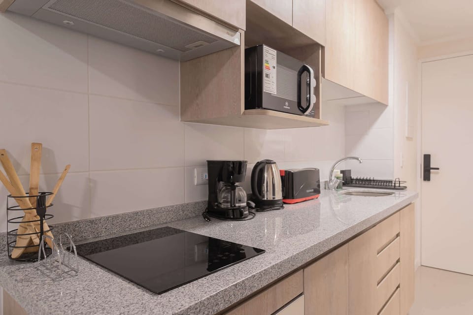 Modern kitchen with essential appliances for a comfortable stay in the heart of the city.