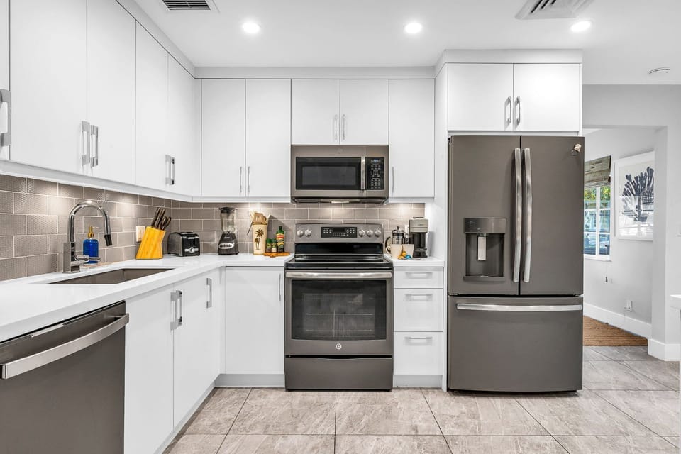 Fully equipped with Nespresso machine, blender, stainless steel appliances, service for 8, and 2 high bar stools for casual dining or remote work.