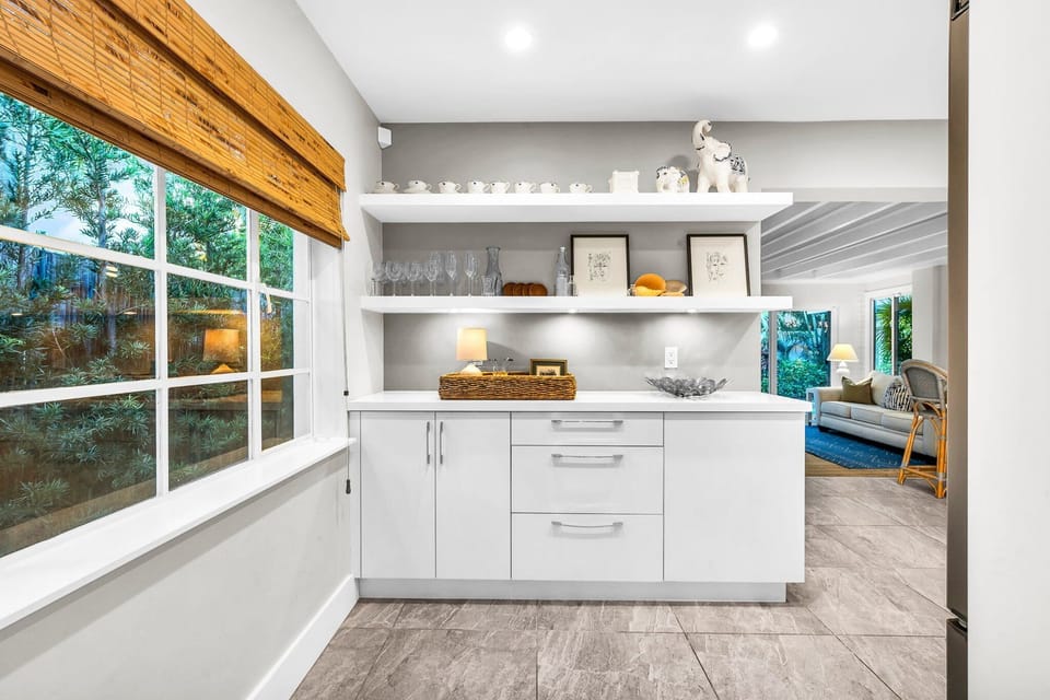 Fully equipped with Nespresso machine, blender, stainless steel appliances, service for 8, and 2 high bar stools for casual dining or remote work.