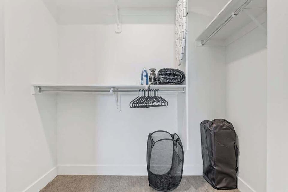 Our walk-in closet makes packing and unpacking a breeze, with plenty of hangers, a flat iron, and laundry bags.