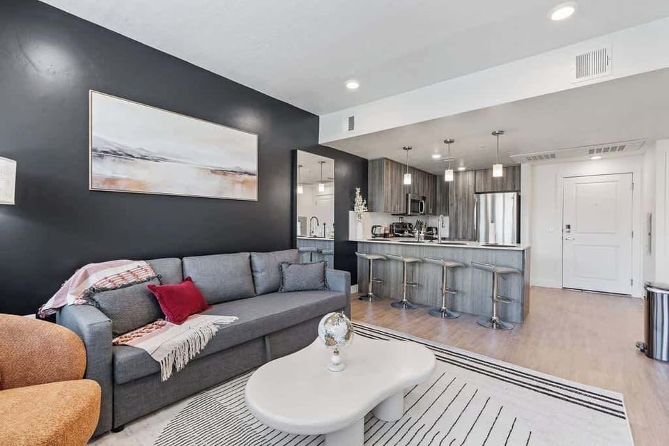 Natural light and cozy vibes – our living room features a TV and beautiful, large windows.