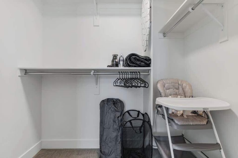 Stay organized in our walk-in closet with ample hangers, laundry bags, and a handy baby stool.