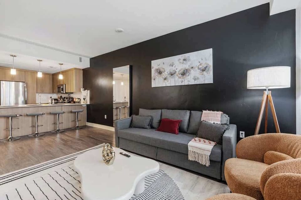 Our living room offers a serene ambiance, with large windows, a cozy seating area, and a designer center table.