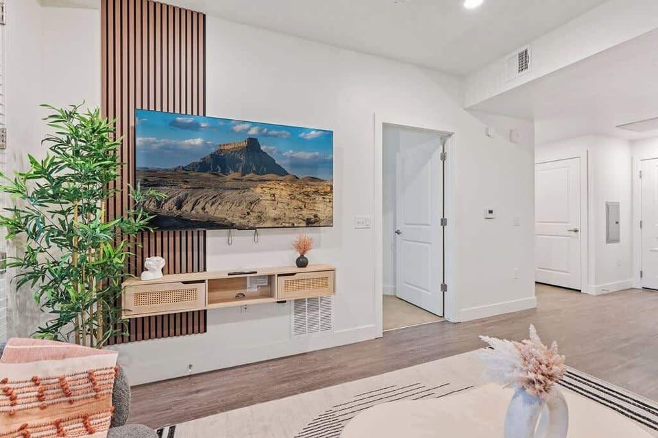 A perfect blend of comfort and design – enjoy the spacious living room with large windows and a cozy setup.