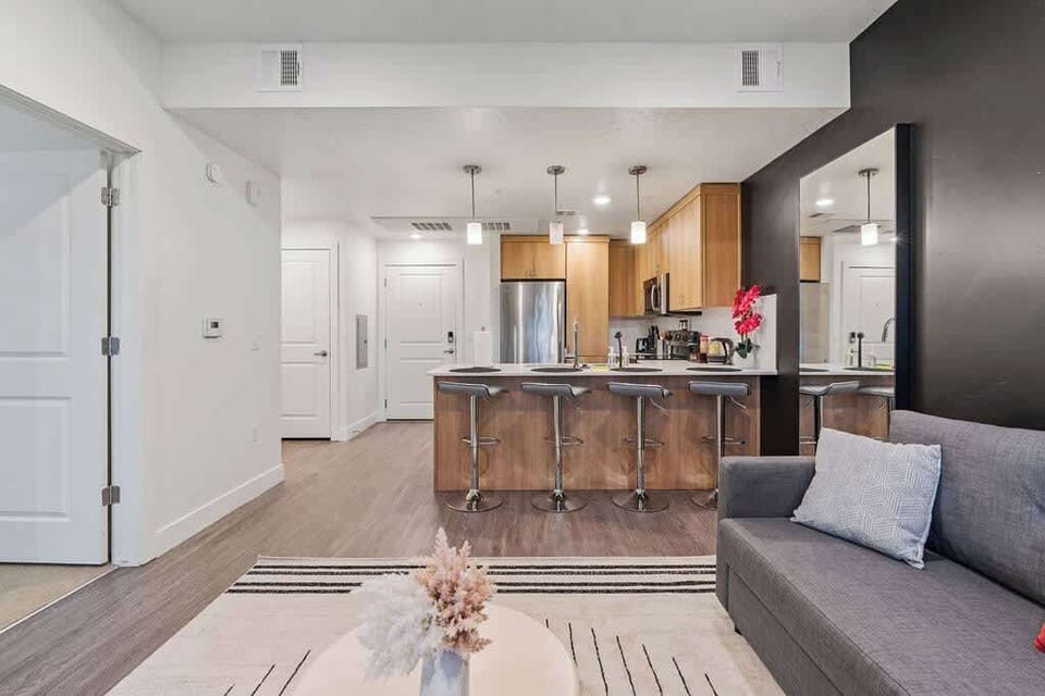 Gather around the bar counter in this spacious kitchen, complete with an oven, dishwasher, and seating for everyone.