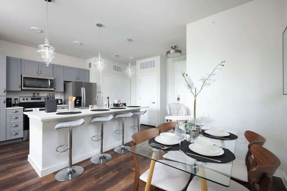 Savor your meals in a stylish dining room with a white orchid centerpiece and a large mirror that brightens the space.