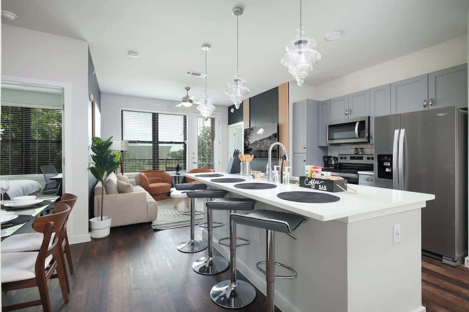 Cook up a storm in our stylish kitchen, featuring full amenities, a bar counter with a sink, and lush mini plants.