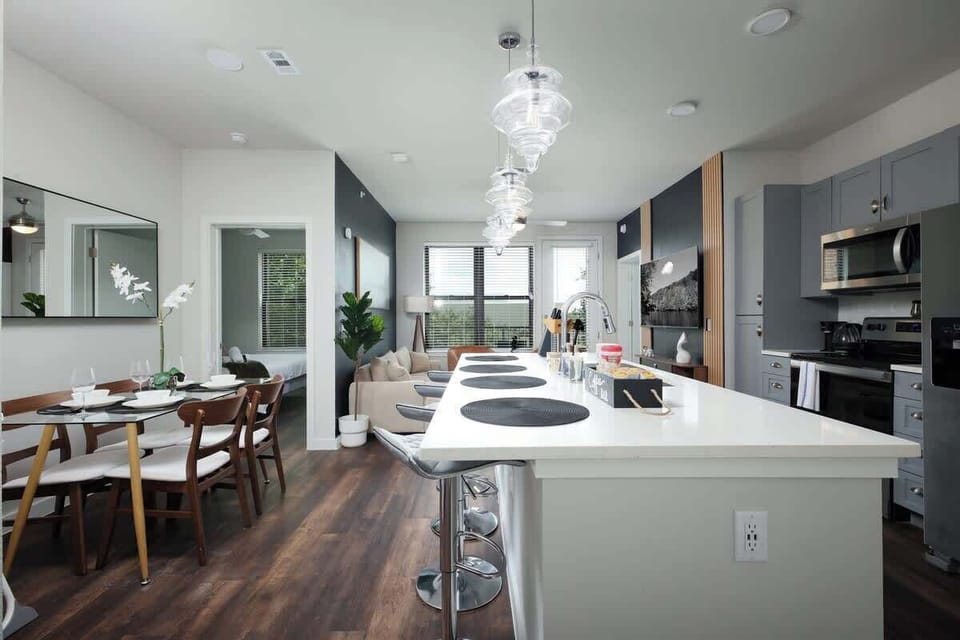 Experience the convenience of a fully-stocked kitchen, with a bar counter, coffee maker, and a fresh touch of mini plants
