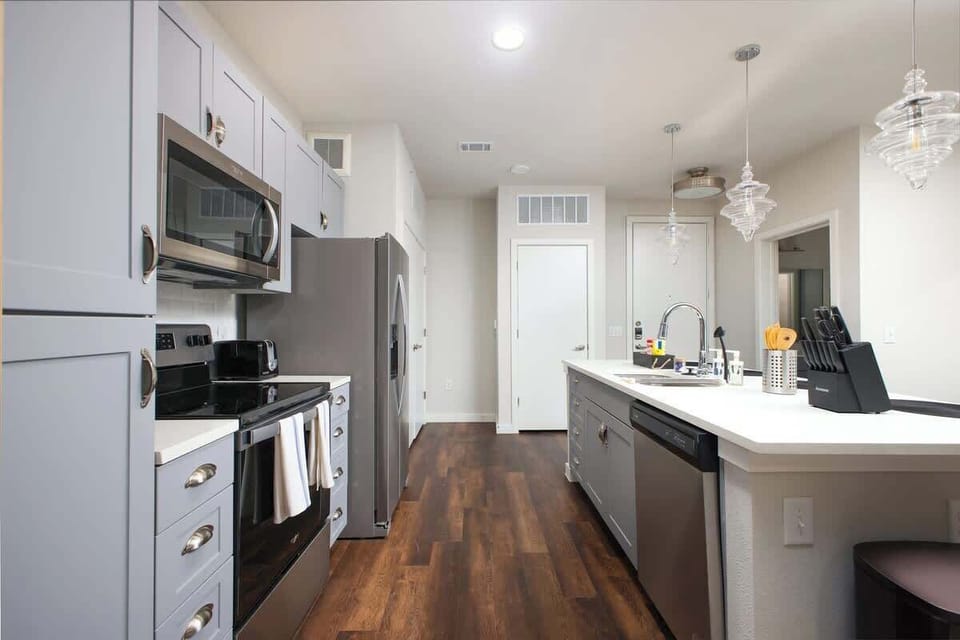 Our kitchen is both functional and inviting, with a bar counter, complete kitchen tools, and mini plants for a fresh, natural touch.