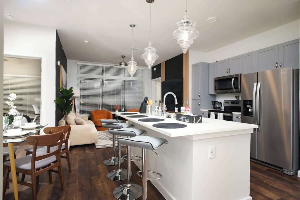 Our kitchen combines practicality with style, featuring a bar counter, sink, complete utensils, and lovely mini plants.