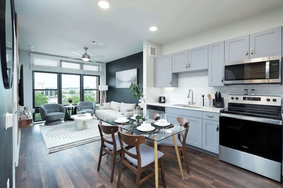 Dine in a space where comfort meets style, with a white orchid centerpiece and a circular mirror.