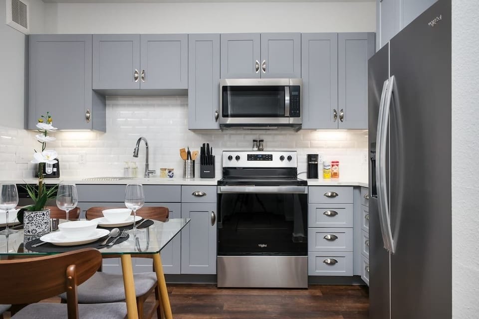 Cook up a storm in our stylish kitchen, featuring full amenities, a bar counter with a sink, and lush mini plants.